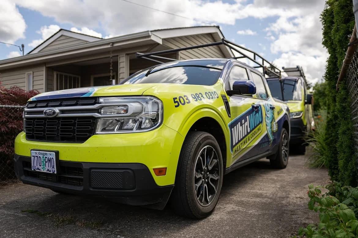 A branded Whirlwind pickup parked in a customer's driveway